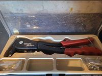 Full set in case showing rivet gun, rivets, case interior