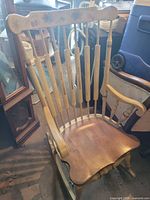 Full view of wooden rocking chair showing back, seat, arms and runners