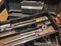 Open Rubbermaid toolbox showing removable tray and miscellaneous tools