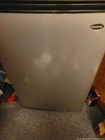 Front view of silver Sanyo compact refrigerator