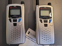 Front view of both Columbia GMRS1 handheld radios showing screens, buttons, and grills