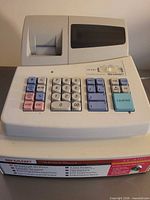 Full view of Sharp XE-A101 cash register showing keypad and display