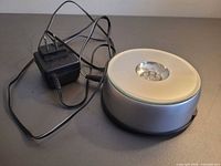 Display base with attached power adapter shown on tabletop