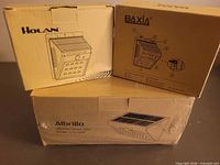 Three retail boxes: Holan, BAXIA, Albrillo solar lights
