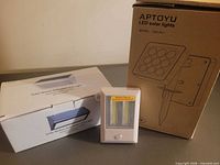 All three lights: APTOYU boxed unit, unbranded boxed unit, compact white light