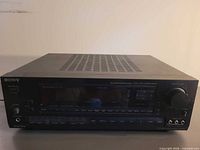 Front view of Sony STR-D660 receiver showing display, buttons, knobs