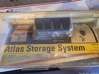 Front view of Atlas Storage System kit in clear blister showing label and contents