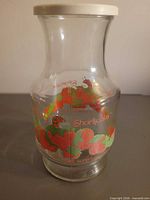 Full view of carafe showing shape, graphics and lid