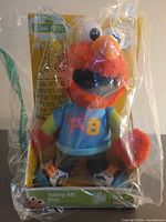 Front view of boxed Talking ABC Elmo plush