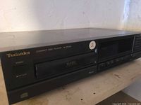 Front and top view of Technics SL-PG100 CD player showing overall condition and controls