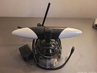 Front view of Thomson antenna on base with coax cable and power adapter