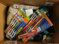 Box overview showing multiple toothbrush packs and other toiletries