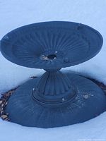 Full view of upside-down fountain basin and pedestal in snow
