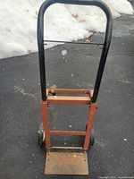 Front view of entire hand truck showing frame, handle, wheels, toe plate