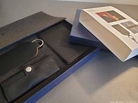 Set opened showing passport holder, luggage tag and key pouch in foam insert