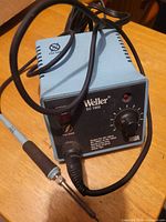 Front view of Weller EC 1002 station with attached iron and cords