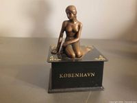 Front view showing mermaid figurine and København lettering