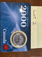 Front of Millennium 2000 Achievement quarter sealed in display card