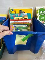 Overall view of blue bin filled with children’s books