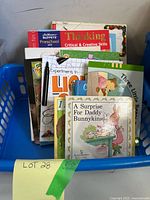 Front view of bin showing variety of book covers including Bunnykins, Little One and science book