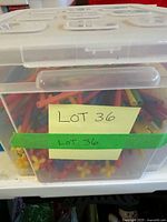 Clear bin containing colorful plastic rods and connectors