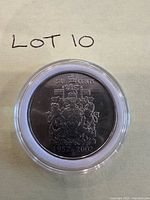 Encapsulated Canadian 50-cent coin dated 1952-2002, reverse side visible