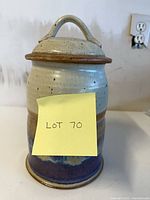 Front view of lidded stoneware canister