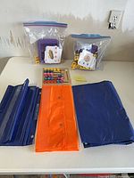 Two pocket charts, two bagged letter-dice games, wooden board