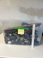 Full view of transparent bin filled with Lego pieces