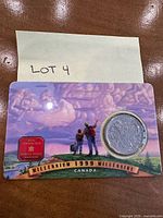 Front of presentation card showing coin and Millennium banner