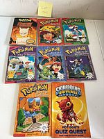 All eight books laid out, front covers visible