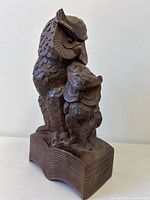 Front view of carved wood owls on book sculpture