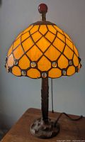 Full view of stained glass lamp illuminated on table
