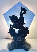 Front view of lamp lit showing knight silhouette and stained glass
