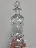 Front view of clear glass Kluk Kluk decanter with stopper