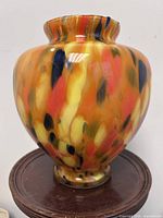 Front view of orange confetti Murano glass vase