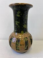 Full view of vase showing mottled glaze and caged band