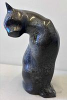 Full left side view of cat sculpture