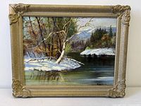 Front view of framed winter landscape painting