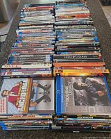 Full lot showing four long rows of DVD and Blu-ray cases on countertop