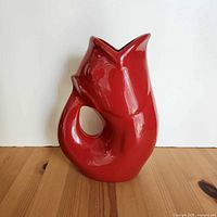Front view of red ceramic gurgle pot pitcher