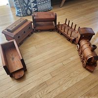 Entire five-piece wooden train laid out on floor