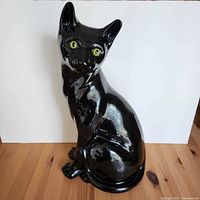 Front view of glossy black ceramic cat statue