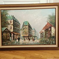 Full view of framed oil painting on floor against wall