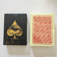 Front of David Blaine deck with autograph next to sealed Killers deck