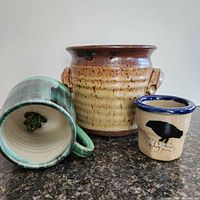 Three pottery pieces grouped on countertop