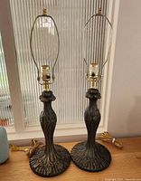 front view of both brass lamp bases with harps