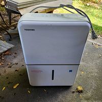 Front view showing Toshiba logo, water tank, power cord