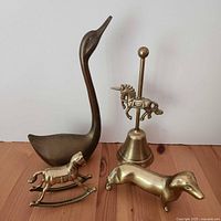 Group shot of four brass animal items