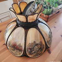 Top angle showing full slag glass shade with printed panels and scalloped crown